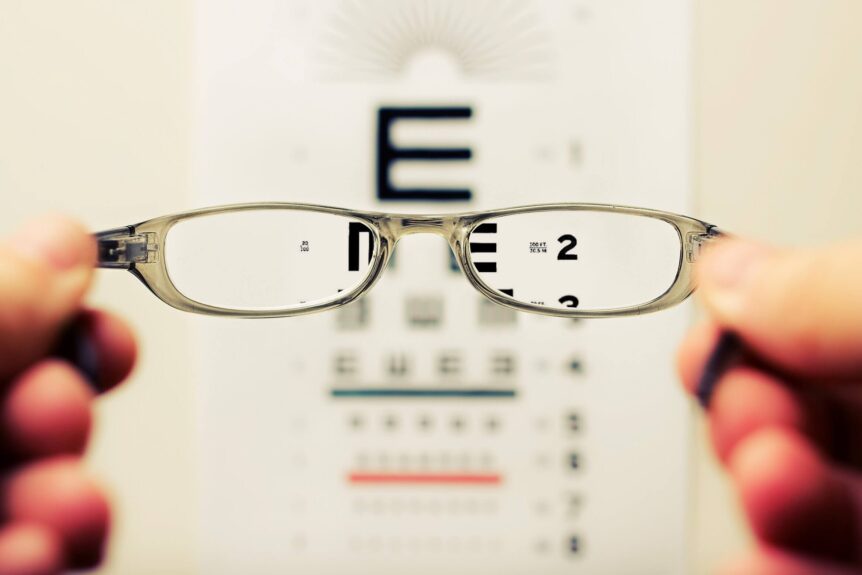 pediatric ophthalmologist holding up glasses for vision test